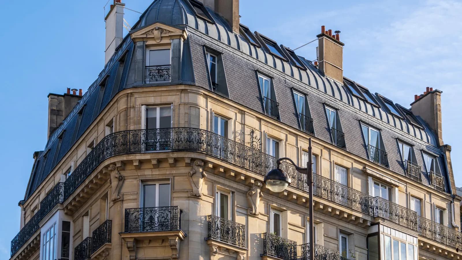 Haussmann building with wrought-iron balconies in Paris, representing market access in France